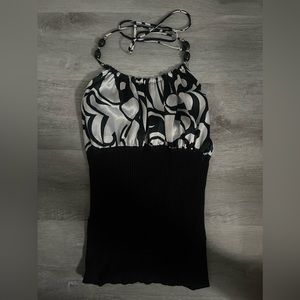 Beautiful halter with geometric details, beading and lettuce trim.